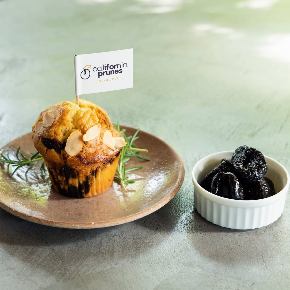 Dough mixed with prune puree and homegrown rosemary, baked to perfection. Topped with almond slices and prunes, with rosemary providing a distinctive aroma.