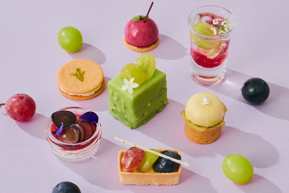A dessert with the appearance of scattered jewels in red, vibrant green, and deep purple hues.