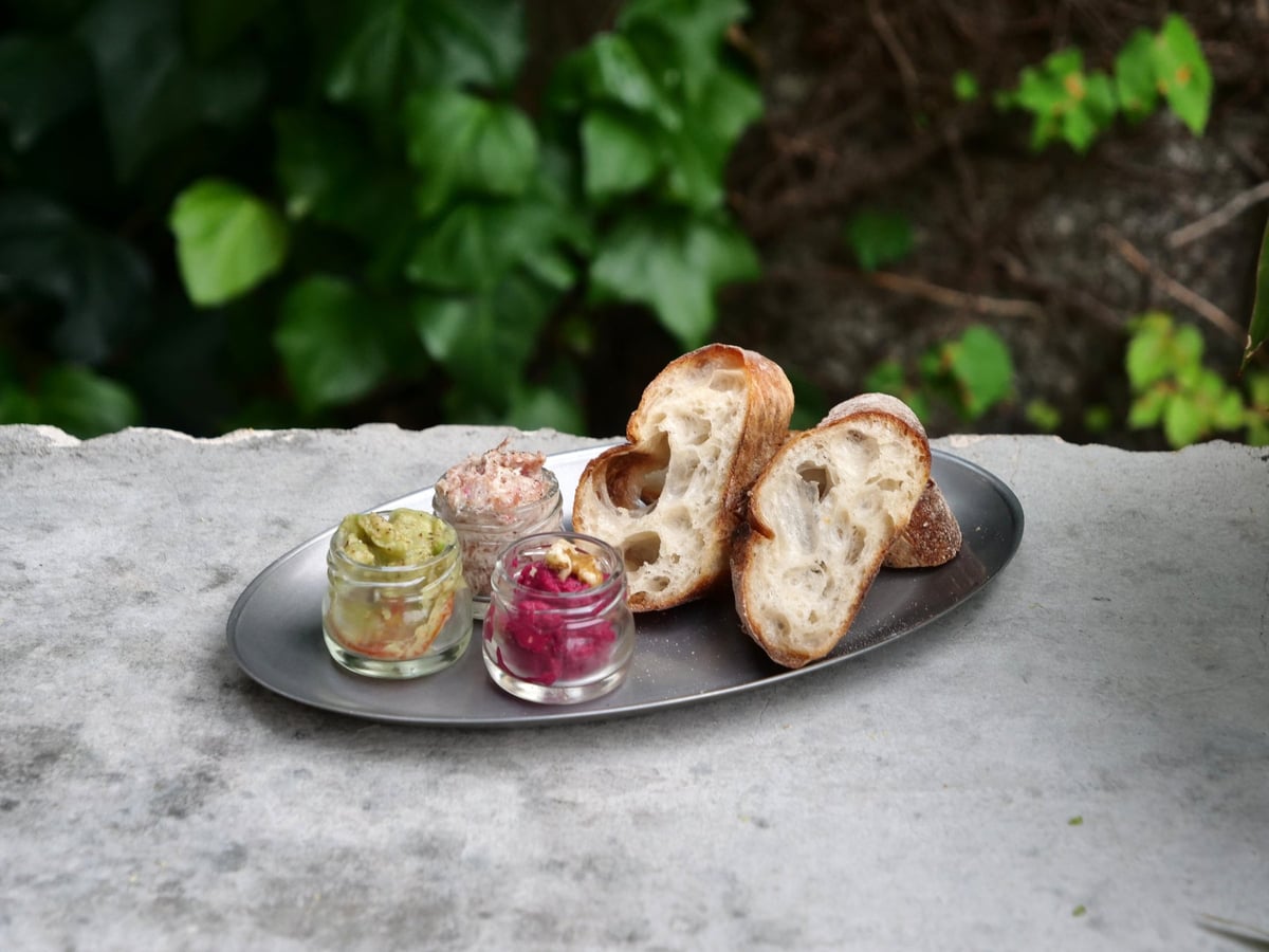 Beet hummus and prosciutto pâté side dishes.