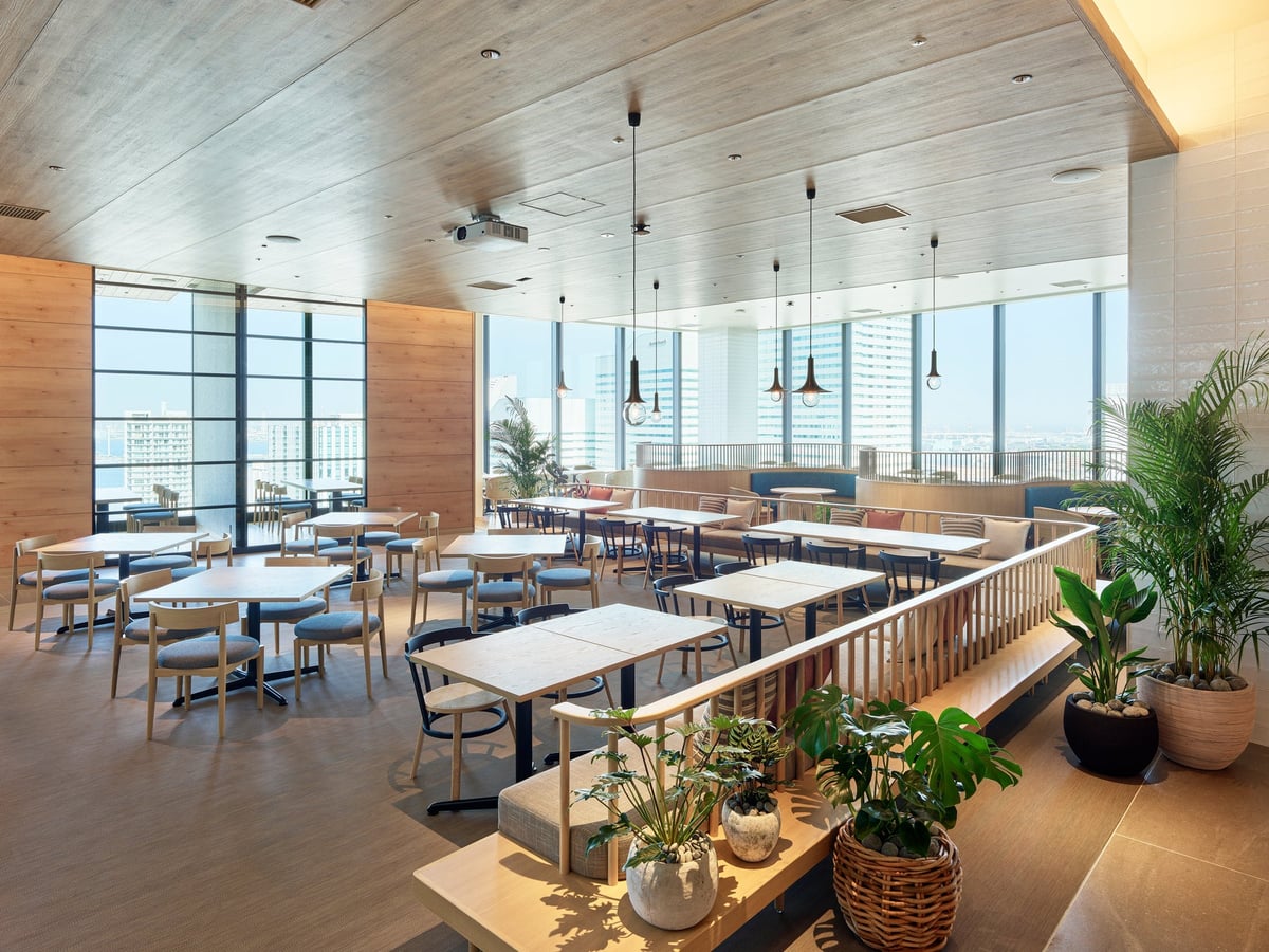 A restaurant with a harbor view through large windows.