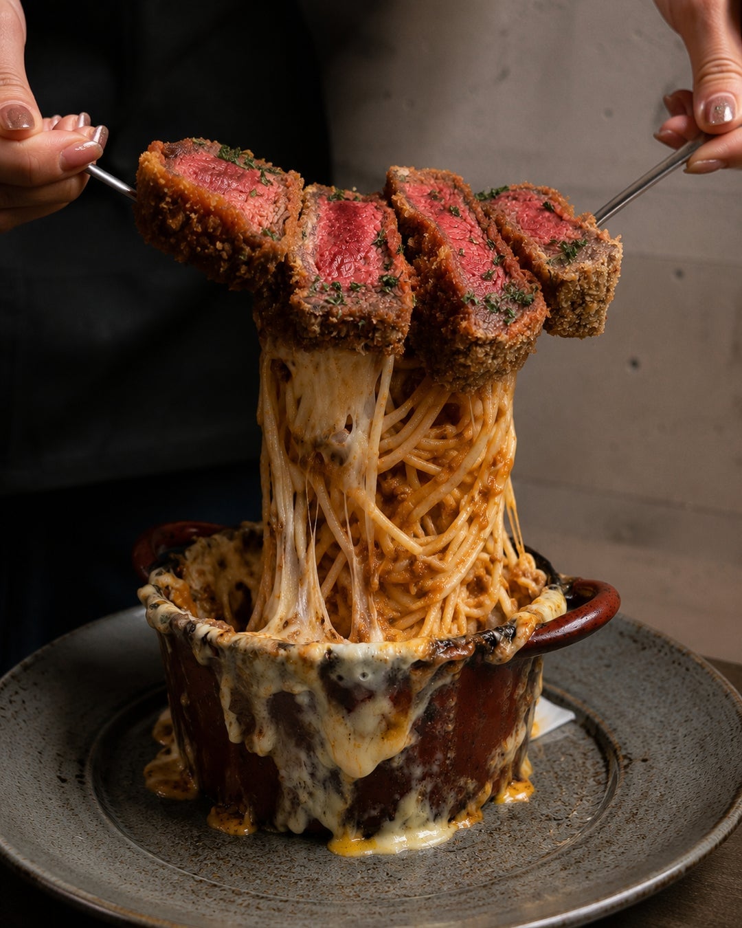 Crispy rare beef cutlet paired with volcano pasta and melted cheese, with the live cheese stretch adding to the appeal.