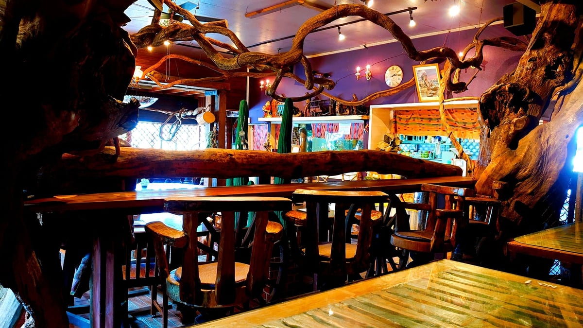 Inside 'Blessings of the Earth,' surrounded by warm wood tones and antique decor, creating a surreal space as if stepping into a storybook world. (Pet-friendly seating available — limited to 2 seats.)