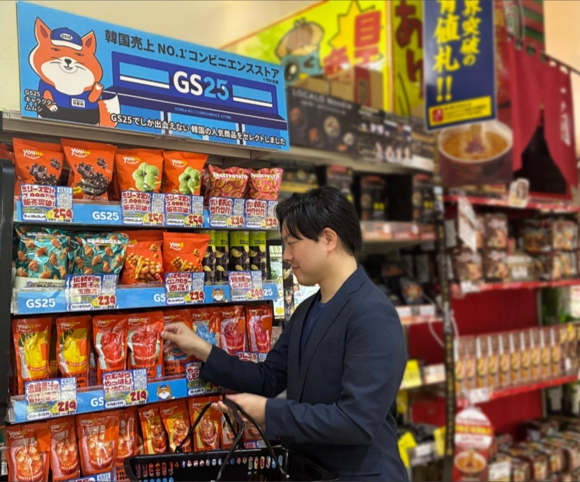 Customer selecting pouch drinks from the GS25 special corner at Don Quijote store