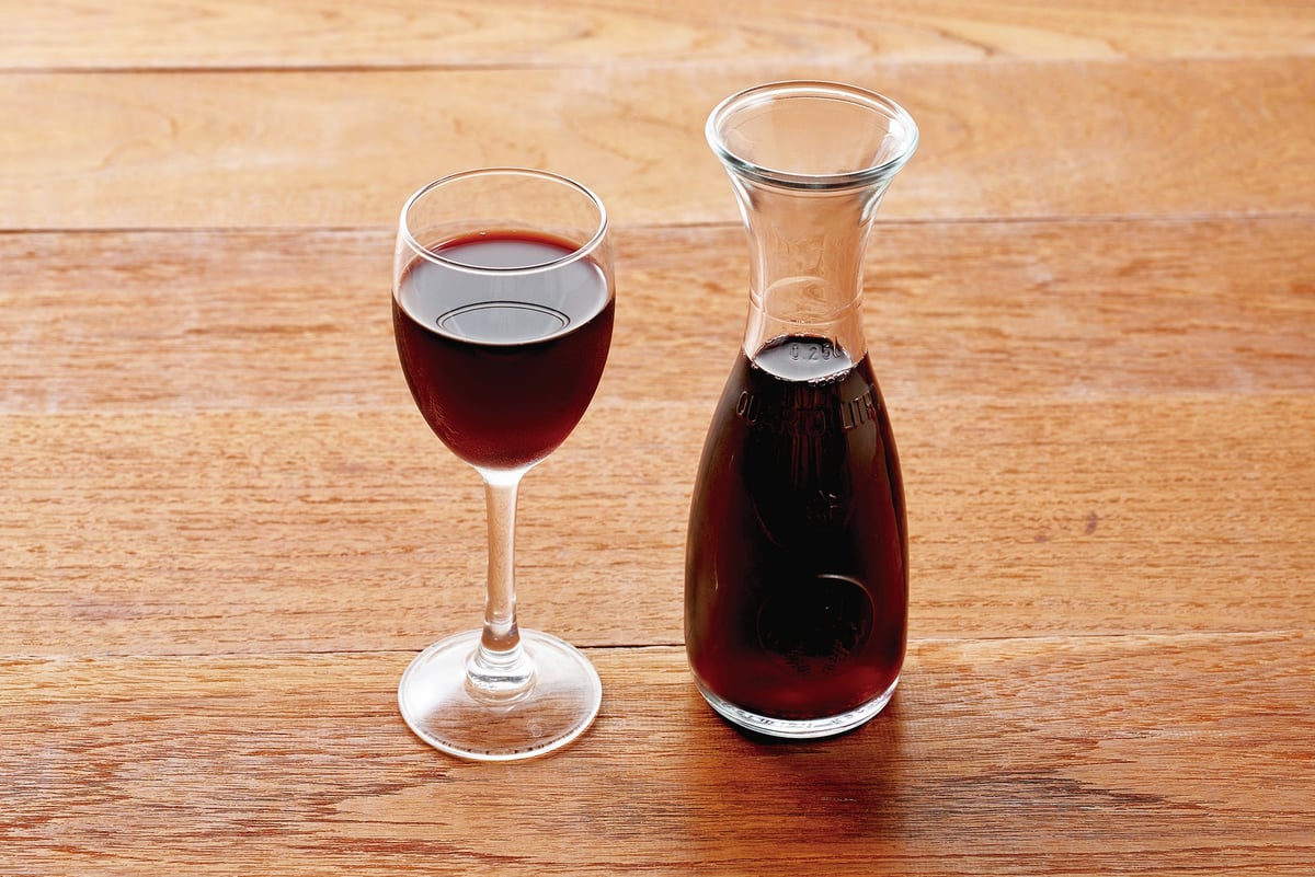 The image shows a decanter of red wine.