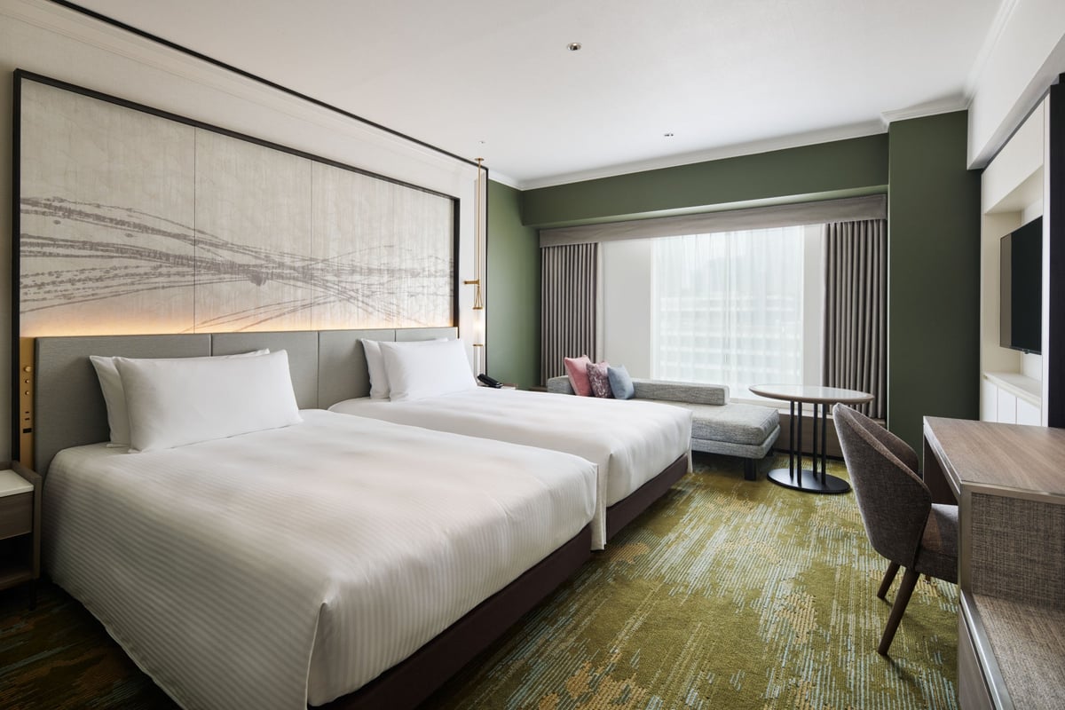 A calm and relaxing guest room with a green theme