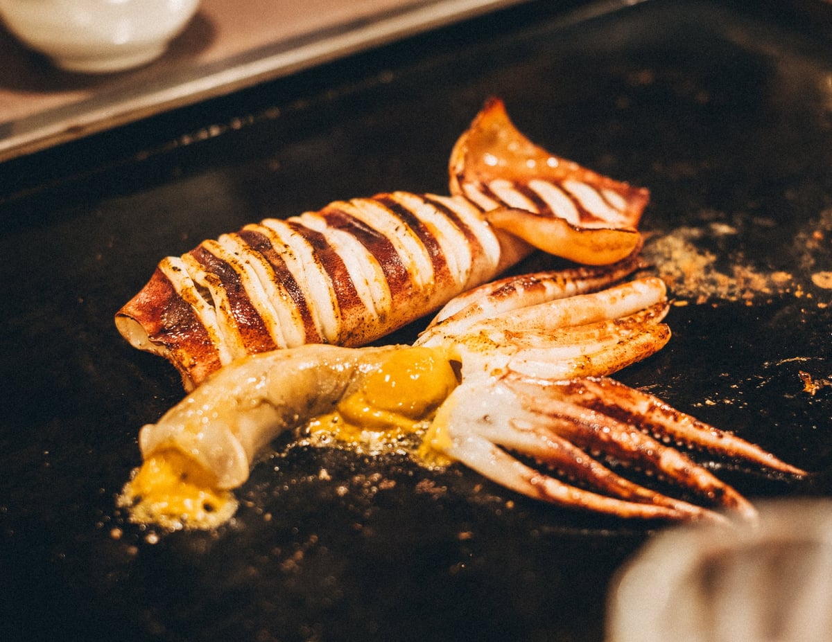 Grilled whole squid (with liver soy sauce), a delicacy where the squid, also edible as sashimi, is grilled with rich liver and butter soy sauce.