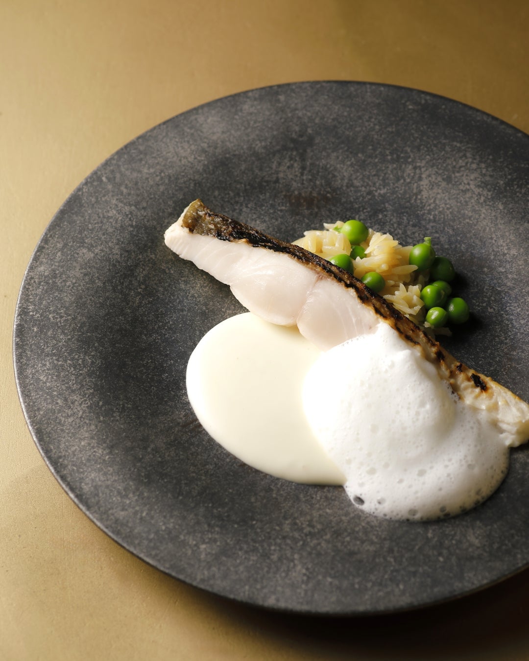 Grilled mackerel pike over charcoal, harmonizing the acidity of tomatoes with rich fermented butter.