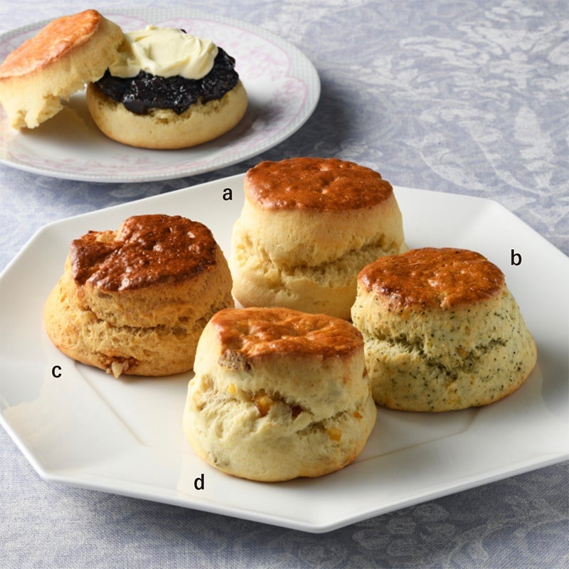 Enjoy a delightful afternoon tea set at Afternoon Tea with the reservation-only Orange Royal Afternoon Tea for ¥9,900 (tax included). At Blue Moon Tea Salon, try the Savory Lunch Plate for ¥3,850 or the Scone & Cake Plate for ¥2,750, available in limited quantities each day. From August 8 to August 21, indulge in the Cake Plate for ¥3,300 at Bake Shop Rotary, or the Savory Plate for ¥3,780. Savor the Landland Bitter Orange Tea with Ice for ¥990 at Farrows, or the Lemon Curd Eaton Mess Parfait for ¥990 at Ishi Kamakura. At Cakers of London, enjoy the Strawberry Chocolate Milk Tea with Matcha for ¥891. Quench your thirst with Cordial Sodas: Rose Bloom or Elderflower each for ¥880 at Lulu Rooms. Sample assorted teas like Earl Grey Lemon Poppy Seed, Pecan Orange, or Apple Caramel for ¥399 each. For a sweet treat, try the Cornish Split from The Balmoral for ¥486 each, or the Plain Scone at Parlamid Cafe & Scone House for ¥454, with other scones priced at ¥508. Part 1 features the Cornish Split for ¥399 each. For baked goods, the Welsh Cake with Apple or Cheddar Cheese is ¥491 each, limited to 100 pieces daily. Enjoy Fish & Chips at Simpsons for ¥2,178. Collectible enamel boxes and mugs from Harrisons Days and Sandringham House are available for ¥121,000, ¥143,000, and ¥20,900 respectively, with the Longest Raining Monarch Silk Scarf priced at ¥74,800.