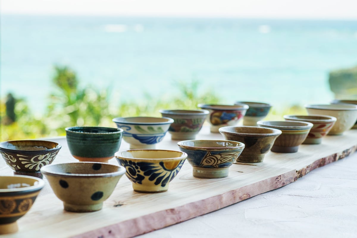 A lineup of unique Yachimun pottery against the backdrop of the sea