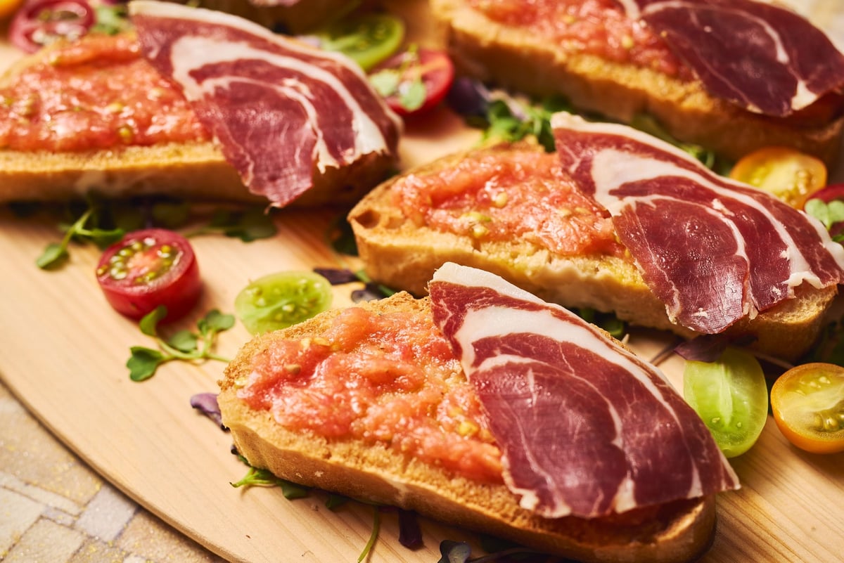 Pan Con Tomate (Spanish-style bread with tomato, ham, and olive oil) *Please note this is an image. Actual menu items may differ.