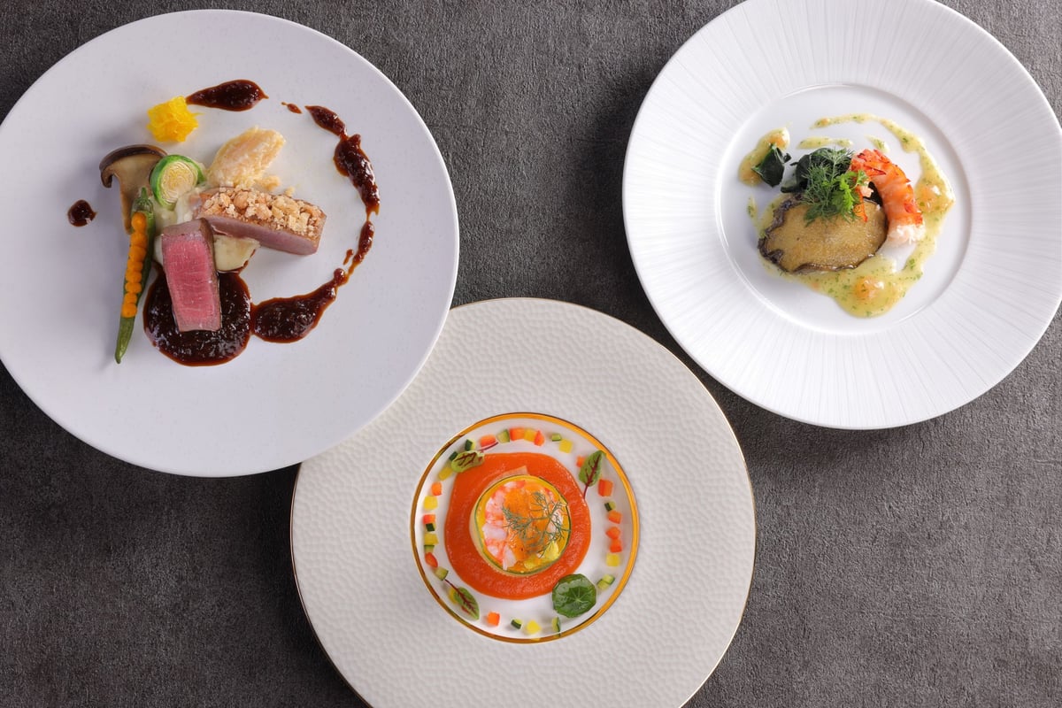 From left to right: Roast Kawachi duck wrapped in wagyu fillet and crumble sale, served with persimmon beignet; Seafood yule with snow crab and sea urchin gâteau, garnished with small vegetables in pipérade coulis; Ezo abalone meunière with lobster tail, prepared in marinier style.