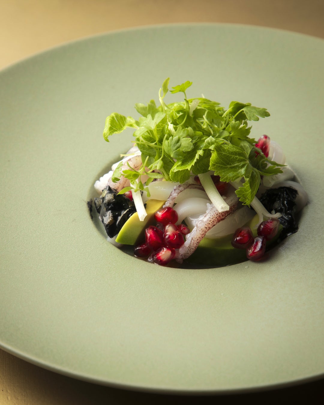 A starter of spear squid with a subtle smoky aroma, reflecting the garden scene transitioning from summer to autumn.