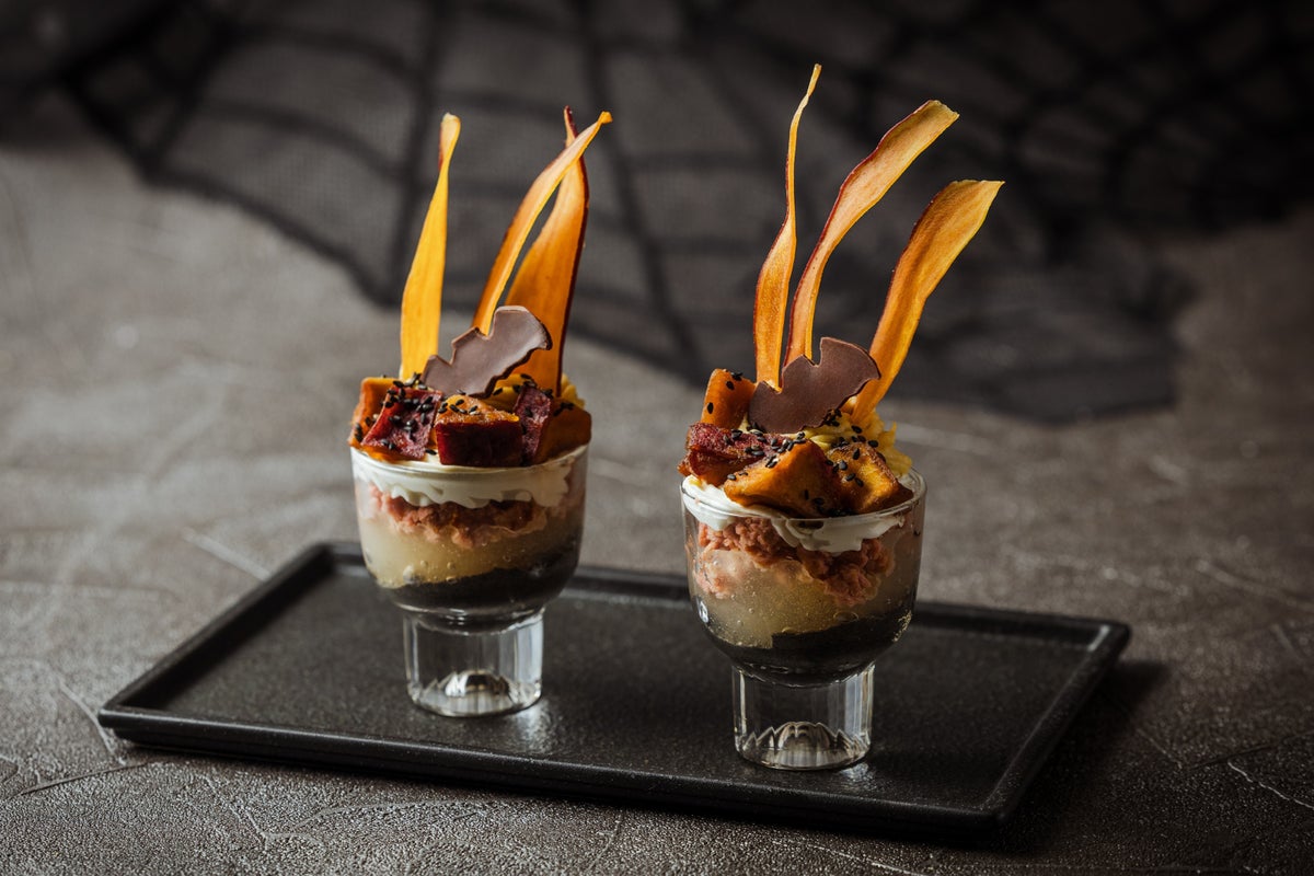 <Sweet Potato Parfait> A mini parfait layered with seasonal flavors like rich black sesame sauce, pear jelly, caramelized apples, and sweet potato cream. A chocolate bat adds a playful Halloween element.” class=”wp-image-41252″>
<figcaption class=