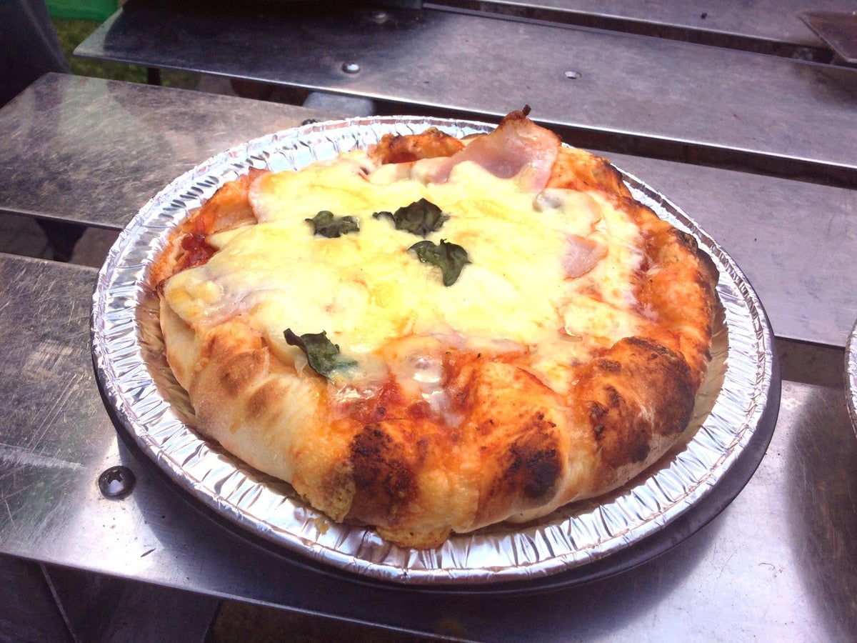 Pizza baked in a handmade stone oven in the garden.