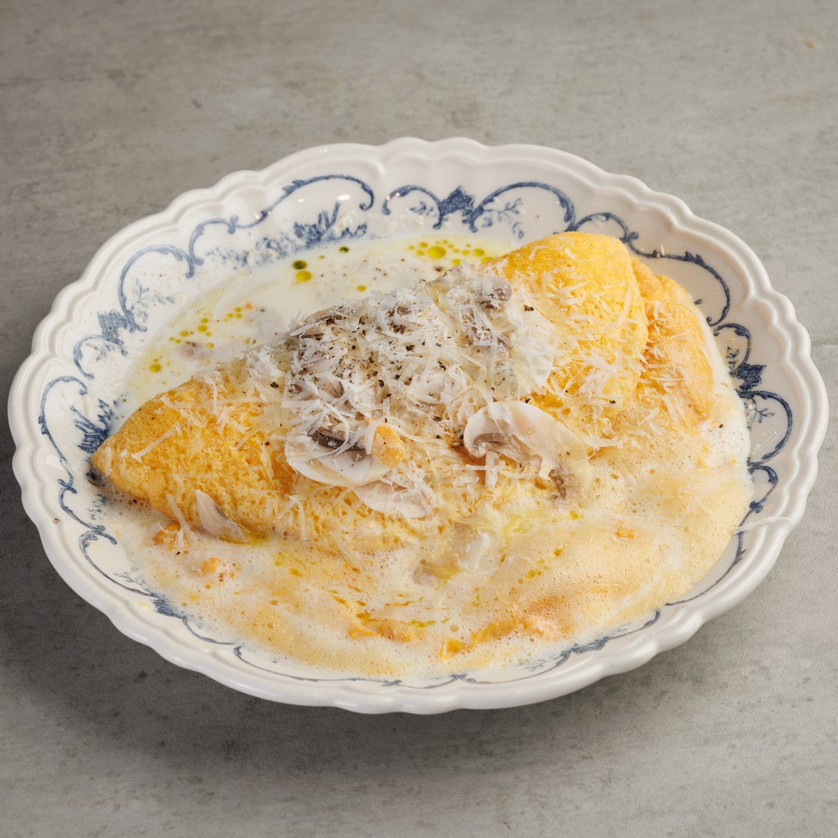 Fluffy Souffle Omelette with Lemon Cream Sauce. The eggs are gently whipped at low speed to incorporate air, then quickly cooked on a hot iron plate to create a light, airy batter. The surface is fragrant and crispy, while the inside melts in your mouth with a delicate, fluffy texture. Since it gradually deflates over time, be sure to enjoy it while it's freshly made. Paired with a refreshing lemon cream sauce that offers a bright acidity and mellow richness, this dish is a gentle and delightful start to your morning.