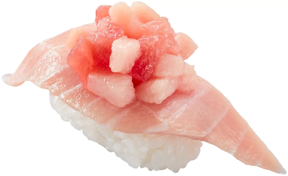 Experience the overlapping aromas in this piece, featuring chūtoro with marinated Minami tuna, topped with yuzu, ¥270 per piece (tax included ¥297)