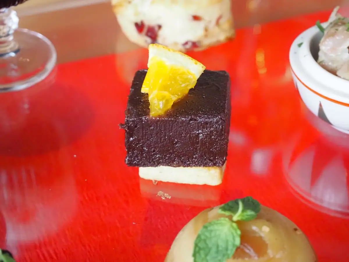 Rich Fresh Chocolate and Cheese Sablé Cake with Orange Aroma. A decadent cake layered with rich fresh chocolate and salty-sweet cheese sablé, infused with orange zest and liqueur, adding a refreshing citrus aroma that complements the deep chocolate flavor.