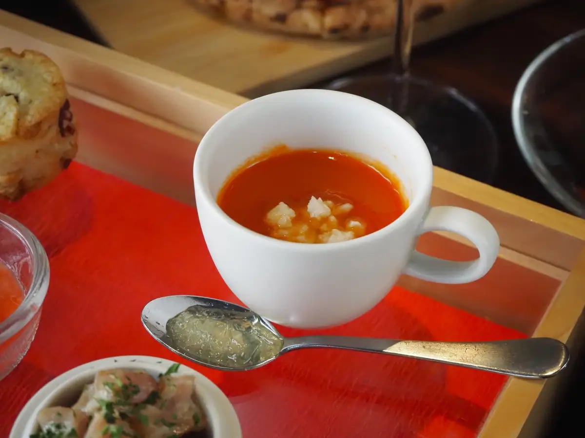 Tomato Zuppa with Ricotta Cheese and Tomato Consommé Jelly. A soup simmered to concentrate the sweetness of tomatoes, combined with the richness and acidity of ricotta. Adding the tomato consommé jelly dissolves into the hot soup, enhancing the tomato flavor.