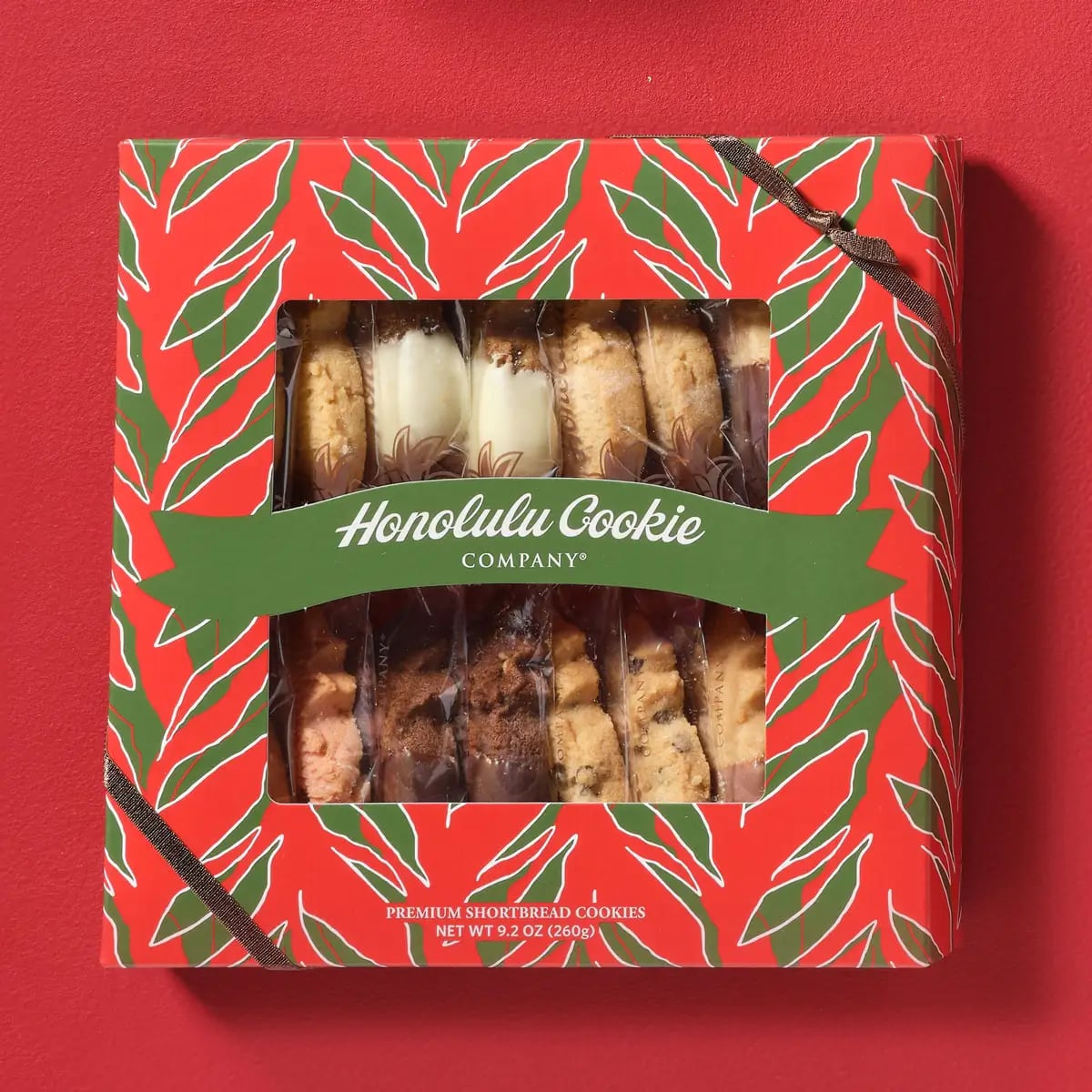 Mele Window Box (M) with 8 varieties and 16 pieces — a glamorous holiday box featuring popular flavors. Includes Hawaiian favorites like Pineapple Macadamia and Guava, plus Dark Chocolate Peppermint Macadamia. A satisfying assortment perfect for gifts or self-indulgence.