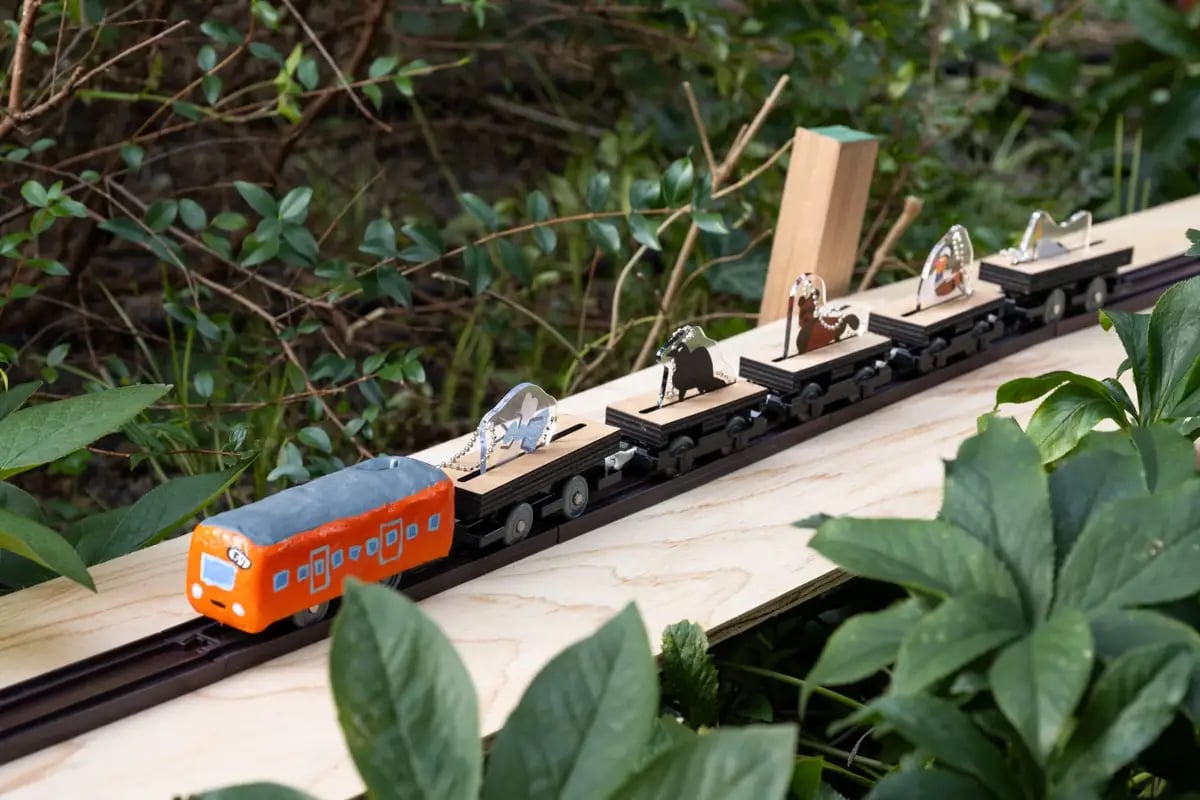 A train runs through the Little Forest during the workshop.